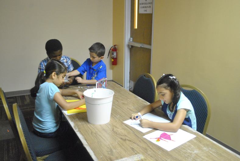 Our Summer Program Kids coloring together
